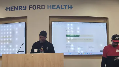 Melvon W. presenting with the Let's Eat! site on the big screens