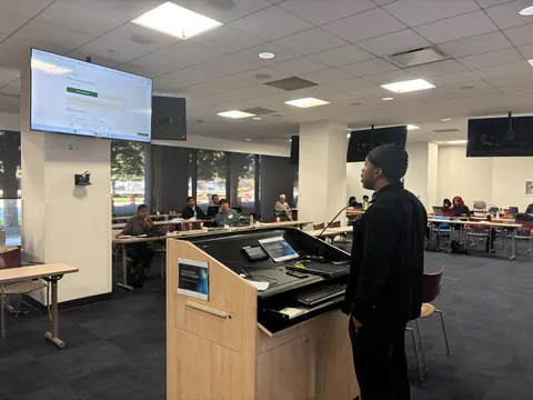 Melvon W. presenting a demo at the podium